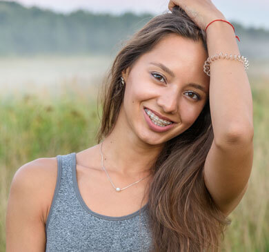 young woman with clear braces smiling