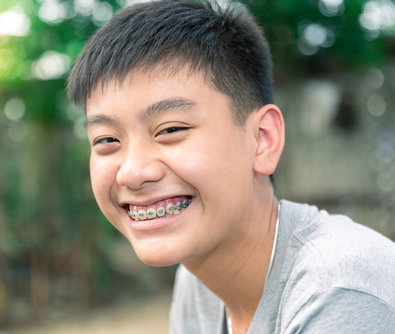young man with metal braces smiling